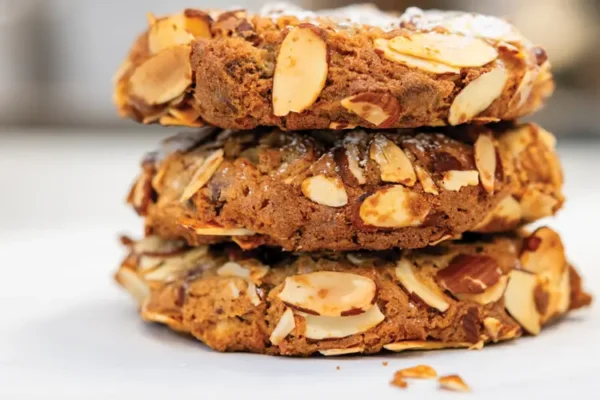 Three almond cookies stacked high.