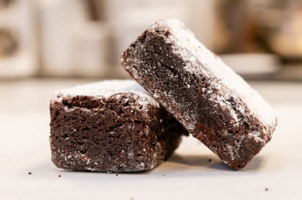 Two powdered chocolate brownies.