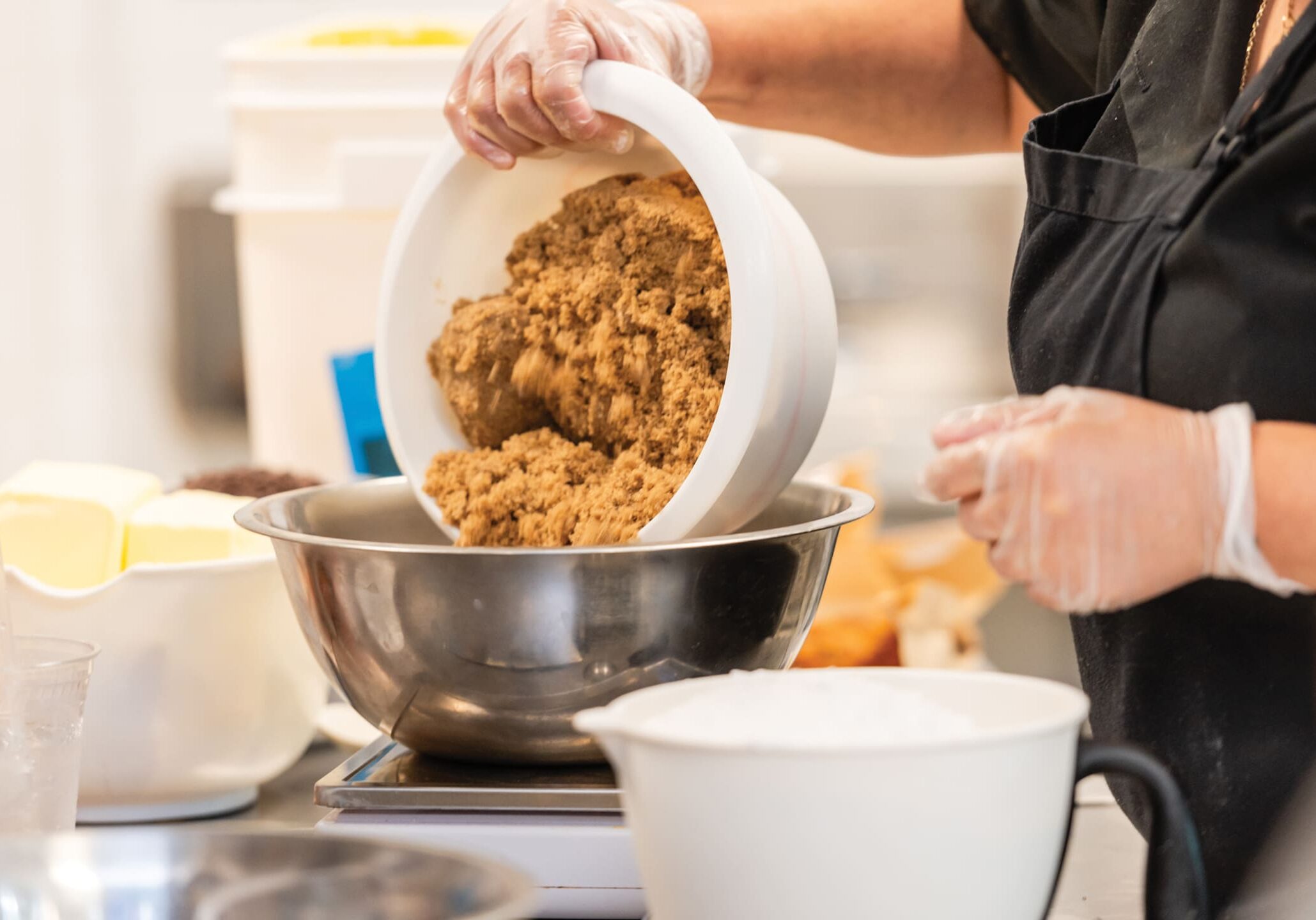 Pouring brown sugar into mixing bowl.