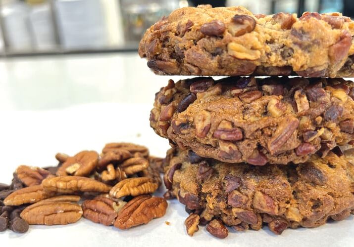 Three pecan cookies with nuts.